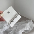 Detail showing two silver wave-shaped metal hairpins on a minimalist display card - Silver Small Wave