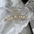 Dettaglio di elegante molletta per capelli con perle, strass e decorazione a fiocco beige - Champagne