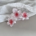 Detail of pink gradient frangipani flower hair claw clip with translucent resin petals - 3-Flower Combination / 3 Flowers Red