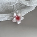Detailed close-up of pink and white gradient frangipani hair claw clip on soft paper - Single Small Flower Style / Single Small Flower Red