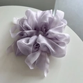 Detail of light purple sheer mesh scrunchie with voluminous pleats and pearlescent finish - Purple