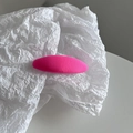 Close-up of bright pink fabric hair clip with a fine knit texture on a white background - Barbie Pink