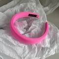 Detail of a thick neon pink handmade headband with fabric texture and side label - Fluorescent Rose Red