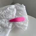 Detail of bright pink macaron snap hair clip with woven texture on white paper - Hot Pink