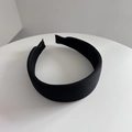 Primer plano de la textura de tela acanalada negra en una diadema ancha acolchada retro - Negro