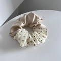 Detail of elegant two-tone scrunchie with champagne satin and black polka dot fabric - Khaki