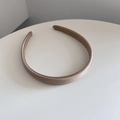 Close-up of champagne gold satin sponge headband with elegant twill texture detail - Khaki