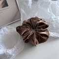Close-up of brown velvet hair scrunchie showing soft fabric texture and elastic design - Light Coffee