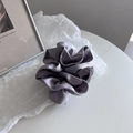 Close-up of gray-purple satin scrunchie showing detailed silk texture and elegant ruffles - Grey Blue
