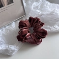 Detailed view of large burgundy velvet scrunchie with rich pleats and soft texture - Orange Pink