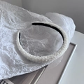 Detail view of the white plush headband with shiny sequins on soft wrinkled paper - 1.5cm / White