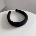 Detail of black wool knit headband showing thick fuzzy texture and handmade woven label - 3CM Wide / Black