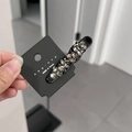 Detail of Korean hair clip with grey rhinestones on black base and nyunyu branding - Black