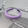 Detail of light purple quilted fabric headband featuring white Hand Made woven label - Purple