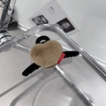 Détail de la pince à cheveux cœur en peluche avec ailes noires et étiquette sport rouge - Kaki