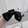 Elegante elastico per capelli in velluto nero con fiocco e dettaglio in metallo per donna - Nero