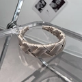 Macro shot of champagne satin braided headband with elegant woven texture detail - Khaki