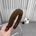 Close-up of dark brown plush teddy fleece headband featuring a woven HAND MADE label - Brown