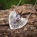 Detail showing vintage heart pendant with purple gems on rustic tree bark background - Heart Gem Silver