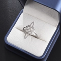Detailed macro view of silver Celtic knot stainless steel ring in a blue jewelry box - Silver