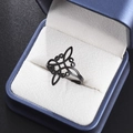 Detail of black stainless steel Celtic knot ring displayed in a blue velvet gift box - Black