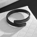 Detail of adjustable black matte ring with engraved Buddhist mantra and religious texture - Black