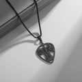 Close-up of black matte guitar pick necklace with musical notes and cutout design - Black