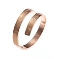 Macro detail of rose gold spiral ring featuring elegant Arabic calligraphy engraving - Rose Gold