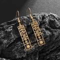 Macro shot of gold Eye of Horus stainless steel rectangular earrings on dark stone - Eye of Horus Style (21766) / Gold