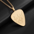 Macro shot of gold guitar pick pendant with music treble clef and heartbeat engravings - Gold