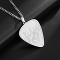Macro shot of silver guitar pick pendant with treble clef and musical wave engravings - Silver
