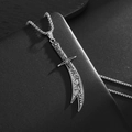 Macro shot of a vintage silver sword pendant with intricate carvings on a box chain - Islamic Dagger Style / 19x66mm / Steel