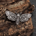 Macro view of gothic skull moth brooch with antique silver finish on natural wood texture - Antique Silver