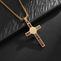 Detail of a gold cross necklace with colorful zircons on a black leather texture - Gold