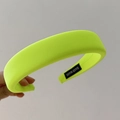 Detail of neon yellow sponge headband showing knitted texture and Hand Made label - Neon Yellow