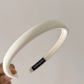Detalle de diadema crema con textura de tela acanalada y etiqueta de 'HAND MADE' - Blanco Leche