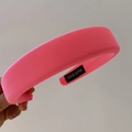 Detail of a bright pink padded sponge headband with HAND MADE label and ribbed texture - Grapefruit Red