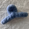 Close-up of a large blue faux fur hair claw clip featuring soft plush material for winter - Blue Gold