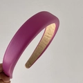 Detail of pink-purple padded headband with litchi grain faux leather texture - Rose Red