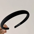Detail of a black twill fabric headband with handmade label and sponge padding - Black