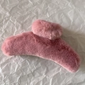 Close-up of soft pink plush hair claw clip on white textured paper background - Rose Pink