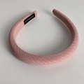 Detail view of pink ribbed sponge headband with a black Hand Made woven label inside - Pink