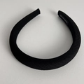 Detail of black twill fabric headband featuring a hand made woven label on the inner tip - Black