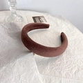 Detail of a brown velvet padded headband featuring a handmade label on a white paper background - Dark Pink