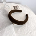 Close-up of handmade wide sponge headband in brown velvet on chic white background - Brown