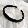 Detailed view of black thickened headband featuring high-quality lychee grain leather texture - Black