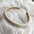 Close-up of cream lambskin headband with soft velvet lining for a premium textured look - Off White