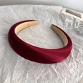 Detail shot of a thick red satin headband with premium silk finish on a white background - Red