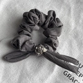 Detail of grey quilted fabric hair scrunchie with sparkling rhinestone sphere ornament - Gray