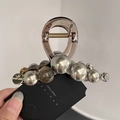 Detail of amber resin hair claw clip with grey faux pearls and rhinestone accents - Gray